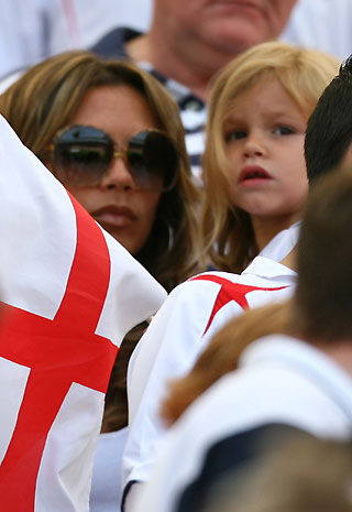 Victoria Beckham, wife of England's David Beckham, waits in the stands with their second son Romeo before the start of the Group B World Cup 2006 soccer match between England and Paraguay in Frankfurt June 10, 2006. 