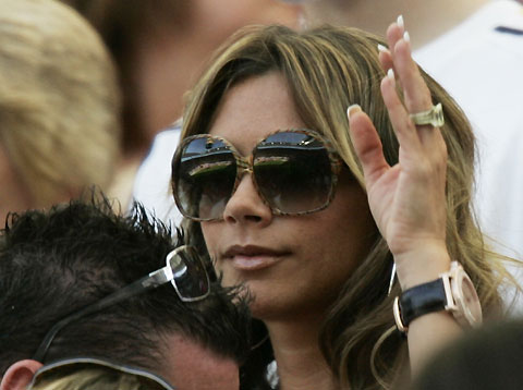 Victoria Beckham, wife of England's David Beckham, waits in the stands with their second son Romeo before the start of the Group B World Cup 2006 soccer match between England and Paraguay in Frankfurt June 10, 2006. 