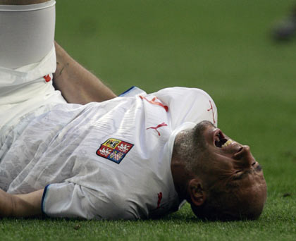 Czech Republic's Jan Koller grimaces in pain on the pitch during the Group E World Cup 2006 soccer match against the U.S. in Gelsenkirchen June 12, 2006.