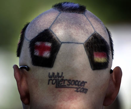 A football supporter sporting a soccer ball patterned haircut is pictured before the World Cup soccer match between U.S. and Czech Republic in Gelsenkirchen June 12, 2006. 