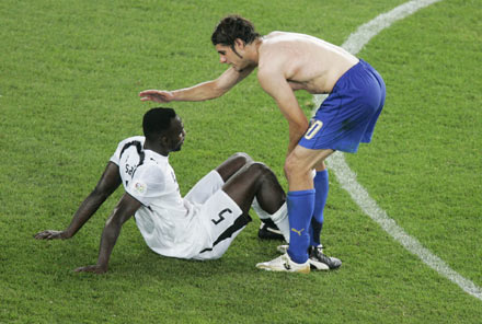 Italy's Simone Perrotta (R) consoles Ghana's John Mensah after Italy defeated Ghana in their Group E World Cup 2006 soccer match in Hanover June 12, 2006.