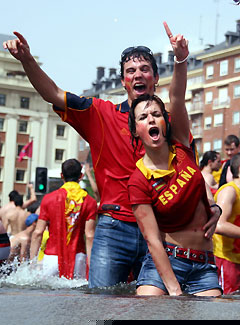 Spanish soccer fans celebrate in a fountain in central Madrid after watching Spain beat Ukraine 4-0 in their Group H World Cup 2006 soccer match on a giant screen in Colon Square, June 14, 2006.