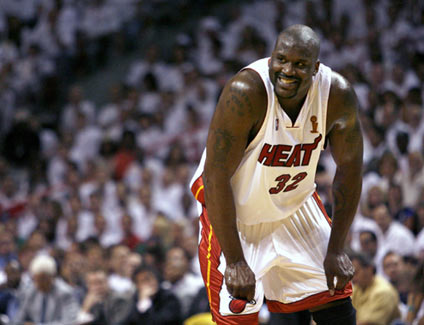 Miami Heat's Shaquille O'Neal smiles at a teammate in the second half of play during Game 4 of their NBA Finals basketball game against the Dallas Mavericks in Miami June 15, 2006.