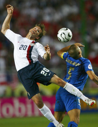 Brian McBride (L) of the U.S. battles for the ball with Italy's Fabio Cannavaro during their Group E World Cup 2006 soccer match in Kaiserslautern June 17, 2006. 