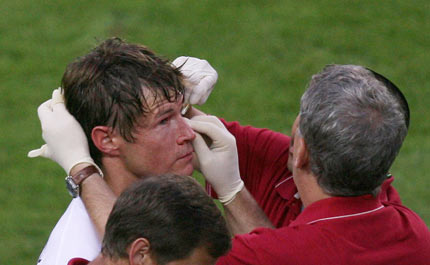 Brian McBride of the U.S. receives treatment after picking up an injury during their Group E World Cup 2006 soccer match against Italy in Kaiserslautern June 17, 2006. 
