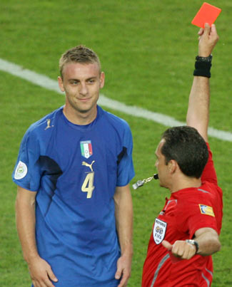 Referee Jorge Larrionda of Uruguay shows a red card to Italy's Daniele De Rossi during the Group E World Cup 2006 soccer match between Italy and the U.S. in Kaiserslautern June 17, 2006. [Reuters] 