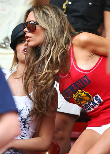 Victoria Beckham (R), wife of England's David Beckham, and Cheryl Tweedie, girlfriend of England's Ashley Cole, wait in the stands before Trinidad and Tobago's Group B World Cup 2006 soccer match against England in Nuremberg June 15, 2006.