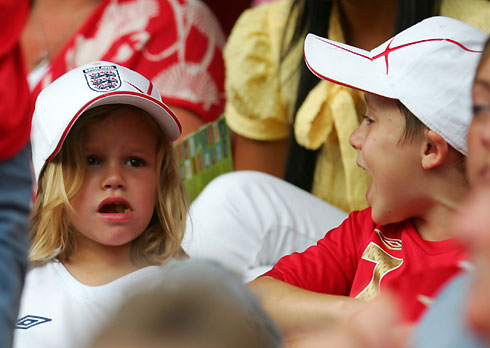 Romeo (L) and Brooklyn Beckham, sons of England's David Beckham and his wife Victoria, sit in the stands before Trinidad and Tobago's Group B World Cup 2006 soccer match against England in Nuremberg June 15, 2006.