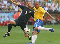 Brazil's Ronaldo (R) battles for the ball with Australia's Craig Moore during their Group F World Cup 2006 soccer match in Munich June 18, 2006. 