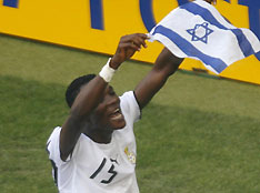 Ghana's John Painstil (R) holds an Israeli flag during their Group E World Cup 2006 soccer match in Cologne June 17, 2006.