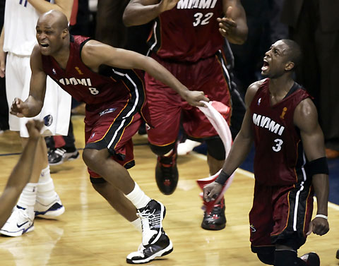Miami Heat guard Dwyane Wade (R) and forward Antoine Walker (L) celebrate after winning the NBA Finals basketball game against the Dallas Mavericks in Dallas, Texas, June 20, 2006.