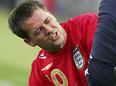 England's Michael Owen receives treatment on the pitch during their Group B World Cup 2006 soccer match against Sweden in Cologne June 20, 2006.