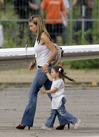 Louise Owen, wife of England striker Michael Owen and daughter Gemma walk to a waiting plane at the airfield in Baden-Baden June 21, 2006, after her husband was injured yesterday during the World Cup match against Sweden. Owen has been ruled out for the rest of the World Cup finals with a knee injury, the Football Association said on Wednesday. 