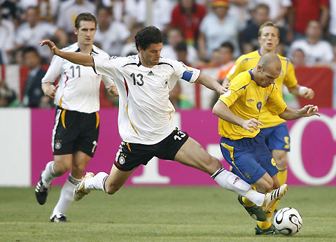 Sweden's Fredrik Ljungberg (9) and Germany's Michael Ballack (13) fight for the ball during their second round World Cup 2006 soccer match in Munich June 24, 2006.