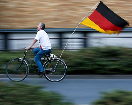 A Germany fan rides his bicycle after the World Cup soccer match between Germany and Sweden, in downtown Frankfurt June 24, 2006.