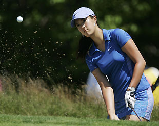 Michelle Wie of the U.S. hits out of the sand onto the fourth green during a practice round at the U.S. Women's Open golf championship in Newport, Rhode Island June 27, 2006.