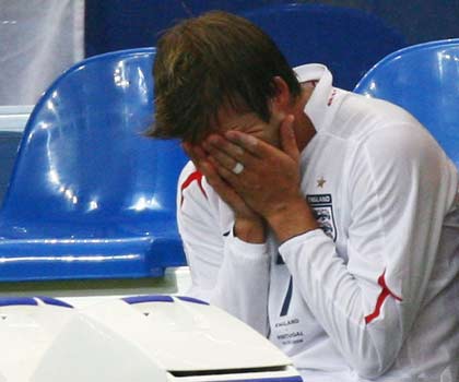 England's David Beckham sits on the bench after his substitution during their World Cup 2006 quarter-final soccer match against Portugal in Gelsenkirchen July 1, 2006. [Reuters]