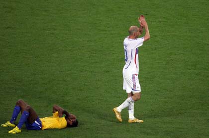 France's Zinedine Zidane (R) applauds as Brazil's Ze Roberto lies on the pitch after their World Cup 2006 quarter-final soccer match in Frankfurt July 1, 2006. 