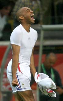 France's Thierry Henry celebrates, as Brazil coach Carlos Alberto Parreira walks in the background, after France defeated Brazil in their World Cup 2006 quarter-final soccer match in Frankfurt July 1, 2006.