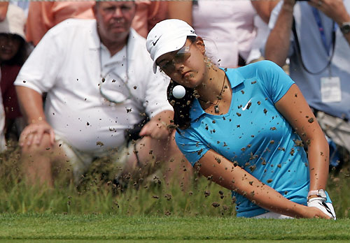Michelle Wie of the U.S. hits out of the bunker on the 13th green during the third round of the U.S. Women's Open golf championship in Newport, Rhode Island July 2, 2006. 