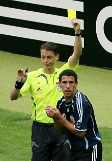 Referee Lubos Michel of Slovakia shows Argentina's Maximiliano Rodriguez a yellow card during their World Cup 2006 quarter-final soccer match against Germany in Berlin June 30, 2006. 