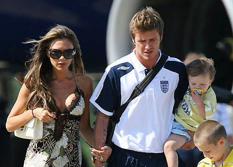 England's former captain David Beckham (L) arrives from Germany with wife Victoria (R) and sons Cruz (2nd L), Romeo (C) and Brooklyn at Stansted airport near London on July 2, 2006. [Reuters]