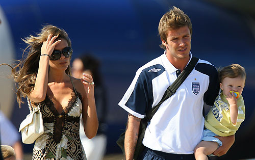 England's former captain David Beckham (L) arrives from Germany with wife Victoria (R) and sons Cruz (2nd L), Romeo (C) and Brooklyn at Stansted airport near London on July 2, 2006. [Reuters]