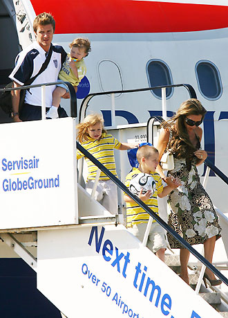 England's former captain David Beckham (L) arrives from Germany with wife Victoria (R) and sons Cruz (2nd L), Romeo (C) and Brooklyn at Stansted airport near London on July 2, 2006. [Reuters]