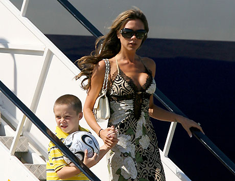England's former captain David Beckham (L) arrives from Germany with wife Victoria (R) and sons Cruz (2nd L), Romeo (C) and Brooklyn at Stansted airport near London on July 2, 2006. [Reuters]