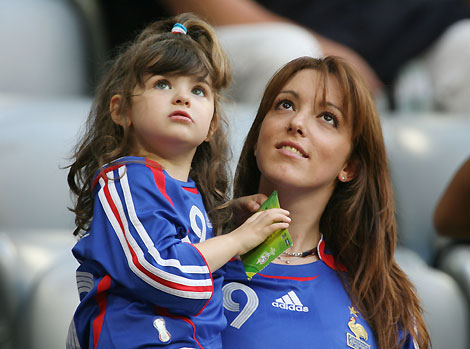 The wife and daughter of France's Willy Sagnol wait in the stands before the World Cup 2006 semi-final soccer match between Portugal and France in Munich July 5, 2006.