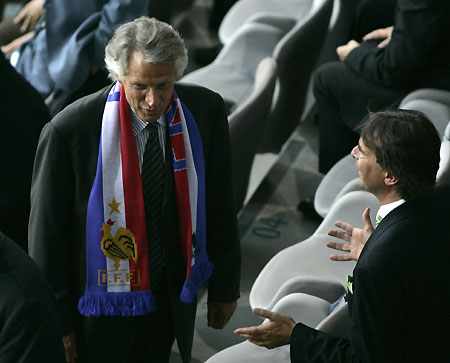 France's Prime Minister Dominique de Villepin (L) waits in the stands before the World Cup 2006 semi-final soccer match between Portugal and France in Munich July 5, 2006.