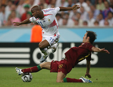 Portugal's Ricardo Carvalho (R) battles for the ball with France's Sylvain Wiltord during their World Cup 2006 semi-final soccer match in Munich July 5, 2006.