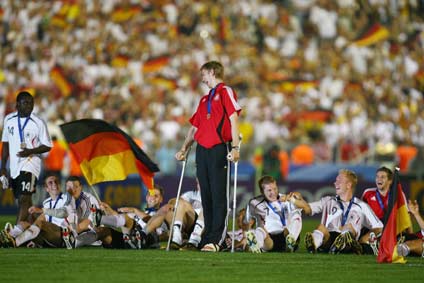 Germany players look at team mate Per Mertesacker (C) after they defeated Portugal in their World Cup 2006 third place soccer match in Stuttgart July 8, 2006. [Reuters] 