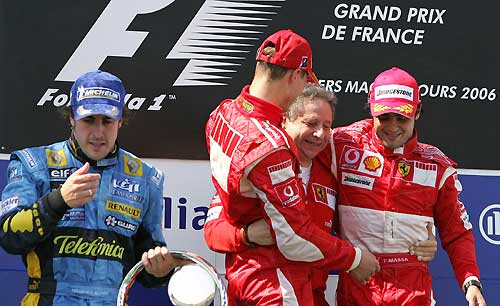 Ferrari's Formula One driver Felipe Massa of Brazil (R) celebrates his third place with team manager Jean Todt (2nd R) and his team mate and winner Germany's Michael Schumacher (3rd R) as Renault's Formula One driver Fernando Alonso (L) celebrates second place at the French Grand Prix at the Magny-Cours circuit July 16, 2006. [Reuters]