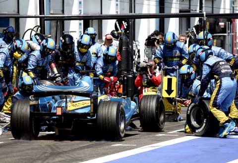 Renault Formula One driver Fernando Alonso of Spain makes a pit stop during the French Grand Prix at the Magny-Cours circuit July 16, 2006. 
