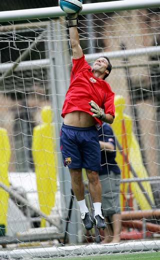 Barcelona's striker Ludovic Giuly from France trains as a goalkeeper during their first training session for the next season at Barcelona's Nou Camp stadium July 17, 2006. 