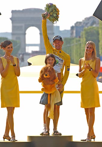 Phonak's team rider Floyd Landis of the U.S. (C) celebrates his overall victory on the podium after winning the 93rd Tour de France cycling race between Sceaux-Antony and the Champs-Elysees in Paris, July 23, 2006. Also on the podium are second placed Ille Balears' team rider Oscar Pereiro Sio of Spain (L) and third placed T-Mobile's team rider Andreas Kloden of Germany (R). 