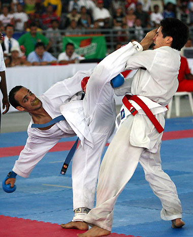 Eynar Tamames of Cuba (L) attacks Colombia's Andres Rendon during the final of the men's under-60kg-kumite of karate-do individual competition at the Central American and Caribbean Games in Cartagena, Colombia, July 24, 2006. Rendon won the gold medal.
