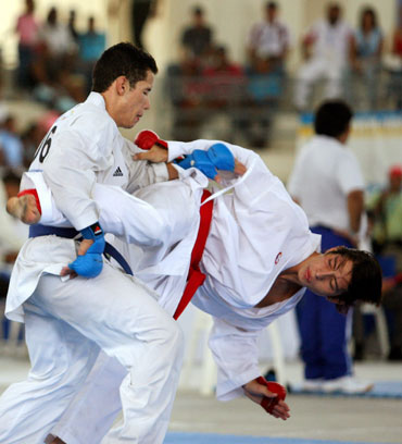 Carlos Puerras of Venezuela (L) competes against El Salvador's Carlos Galan during the men's under -60kg-kumite of karate-do individual competition at the Central American and Caribbean Games in Cartagena, Colombia, July 24, 2006.