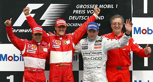 Ferrari Formula One drivers Felipe Massa of Brasil, Michael Schumacher of Germany, McLaren driver Kimi Raikkonen of Finland and Ferrari technican Paolo Martinelli (L-R) celebrate after the German Formula One Grand Prix at the Hockenheim race track, July 30, 2006. Schumacher won the race ahead of Felipe Massa and Kimi Raikkonen.