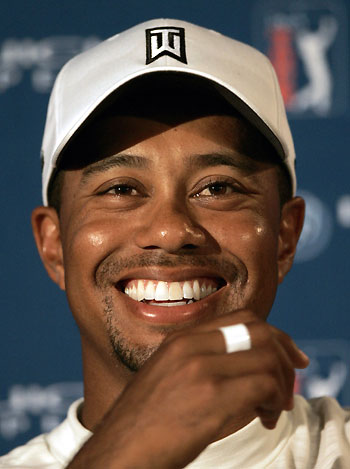 Tigers Woods laughs during an interview following the Buick Open Pro-Am golf tournament in Grand Blanc, Michigan August 2, 2006. 