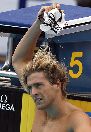Helge Meeuw of Germany takes off his swimming cap after participating in the heats of the men's 50 m backstroke event at the European Aquatic Championships in Budapest August 2, 2006.