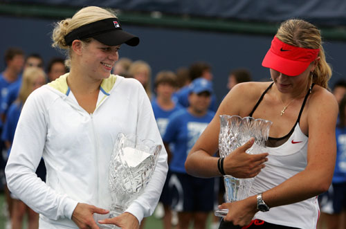 Kim Clijsters of Belgium (L) looks at Russia's Maria Sharapova holding the championship trophy after she lost to Sharapova in the final of the Acura Classic women's tennis tournament in Carlsbad, California August 6, 2006.