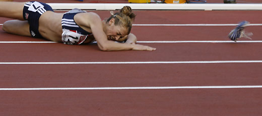Jemma Simpson from Great Britain lies on the track after losing her shoe and falling in a woman's 800 m heat at the European athletics championships in Gothenburg, August 7, 2006.