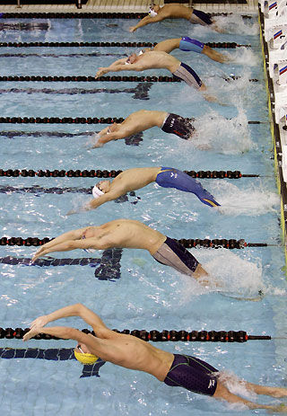 Swimmers start their men's 100m backstroke heat during the Pan Pacific 2006 swimming championships in Victoria, British Columbia, August 17, 2006. 