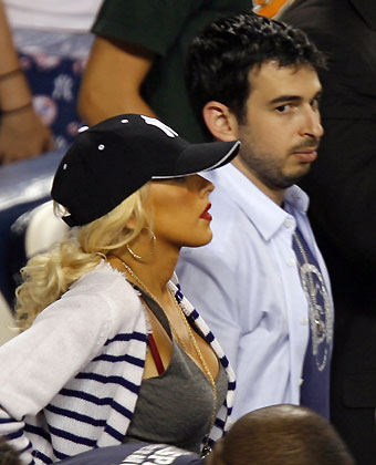 Christina Aguilera and her new husband Jordan Bratman watch the New York Yankees play the Baltimore Orioles during their American League baseball game in New York's Yankee Stadium, August 16, 2006. 