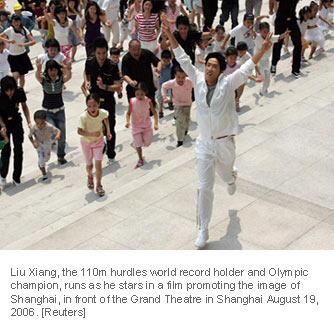 Liu Xiang, the 110m hurdles world record holder and Olympic champion, runs as he stars in a film promoting the image of Shanghai, in front of the Grand Theatre in Shanghai August 19, 2006. [Reuters]
