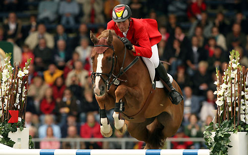 Germany's Ludger Beerbaum clears a jump on L'Espoir during the 2nd qualification for the FEI World Showjumping Championship at the World Equestrian Games in Aachen August 30, 2006.