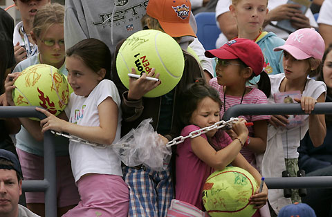Young fans force their way courtside for autographs after Australia's Lleyton Hewitt won his match against Spain's Albert Montanes at the U.S. Open tennis tournament in New York, August 30, 2006.