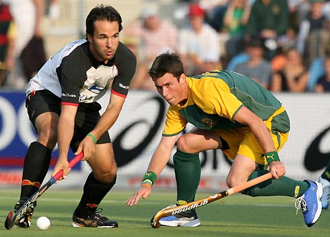 Germany's Tibor Weissenborn (L) fights for the ball with South Africa's Wayne Madsen during their Men's Field Hockey World Cup match at the Warsteiner Hockey Park stadium in Moenchengladbach September 12, 2006. 